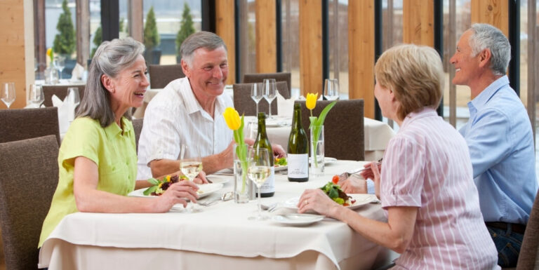 Elderly Friends Enjoying Fine Dining Together at Memory Care Facility