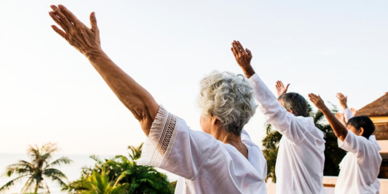 Elderly Group Practicing Morning Stretches at Memory Care Facility